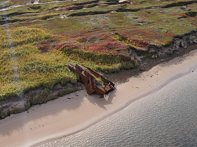 Iron plating and framing half buried in the sand on the right bank at the mouth
                    of the Blanc-Sablon River.